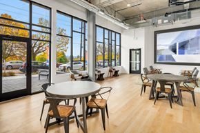 Seattle apartment for rent - a dining room with tables and chairs and large windows