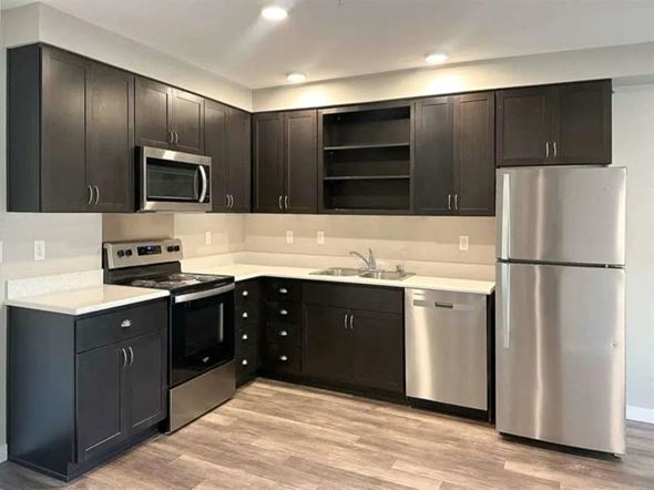 Marysville apartment for rent - a kitchen with black cabinets and stainless steel appliances