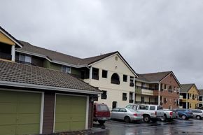 Marysville apartment for rent - a row of houses with cars parked in a parking lot