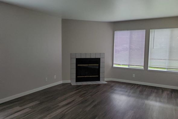 Marysville apartment for rent - a living room with a fireplace and wooden floors
