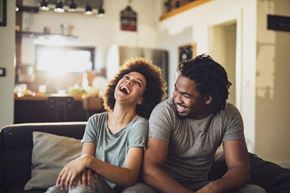 Marysville apartment for rent - a man and woman sitting on a couch laughing