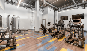 Everett apartment for rent - a gym with cardio machines and weights on a wooden floor