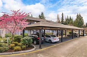 Lynnwood apartment for rent - A parking lot with cars and a building in the background.