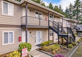 Lynnwood apartment for rent - A building with a balcony and a staircase leading to it.