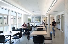 Seattle apartment for rent - A group of people are sitting at tables in a cafeteria style dining area.