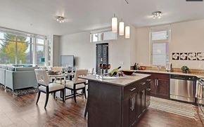 Lynnwood apartment for rent - A kitchen with a wooden floor and a black fridge.