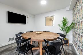 Centralia apartment for rent - A modern dining room with a round wooden table and black chairs.