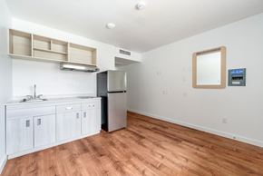 Centralia apartment for rent - A kitchen with white cabinets and a wooden floor.