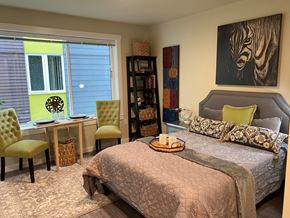 Seattle apartment for rent - a bedroom with a bed and a desk and a painting of a zebra