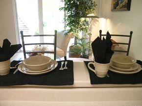 Federal Way apartment for rent - a dining room table with plates and utensils and a window