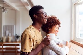 Marysville apartment for rent - A man and a woman are standing close together, holding cups and smiling.