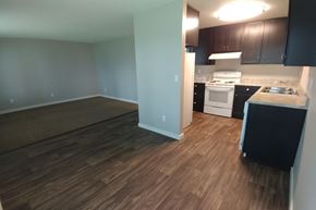 Marysville apartment for rent - A kitchen with a white stove top oven and black cabinets.