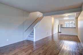 Snoqualmie townhouse for rent - A spacious room with wooden floors and a staircase.