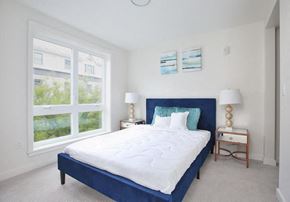 Quincy apartment for rent - a bedroom with a large bed and a large window