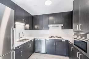 Quincy apartment for rent - a kitchen with black cabinets and stainless steel appliances