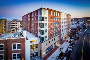 Quincy apartment for rent - an aerial view of a building in the city at dusk