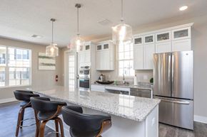 Lancaster townhouse for rent - a kitchen with a marble counter top and a stainless steel refrigerator
