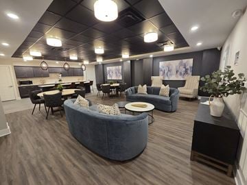Delaware townhouse for rent - A modern living room with a grey sofa and a black coffee table.