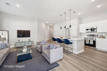 Columbus apartment for rent - A modern living room with a white sofa set and a glass coffee table.
