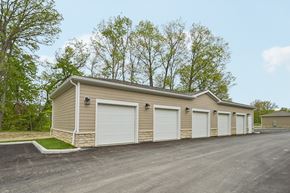 Delaware townhouse for rent - A building with a grey roof and white garage doors.