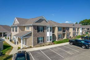 Lancaster townhouse for rent - an apartment building with cars parked in a parking lot