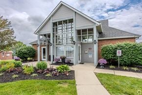 Springfield apartment for rent - A building with a grey facade and a grey roof with a glass door and windows.