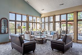 Hilliard apartment for rent - A living room with a large window and a view of a backyard.