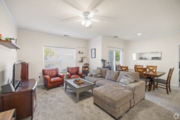 Beavercreek apartment for rent - a living room with a couch and a table with chairs