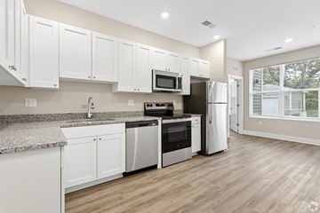 Delaware apartment for rent - A kitchen with white cabinets and a granite countertop.