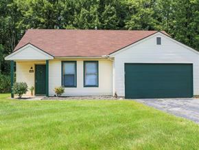 Blacklick apartment for rent - A house with a green door and a garage door.