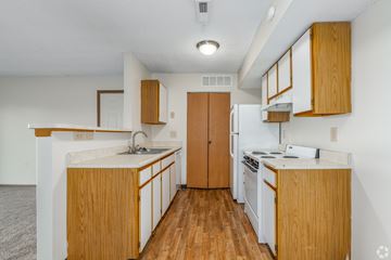 Lancaster apartment for rent - A kitchen with wooden cabinets and a white counter.