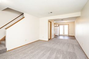 Blacklick apartment for rent - A spacious living room with a staircase on the left side.
