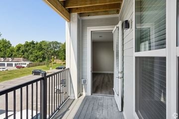 Columbus apartment for rent - A white house with a wooden deck and a glass door.