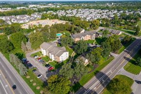 Blacklick apartment for rent - A large building with a parking lot in front of it.