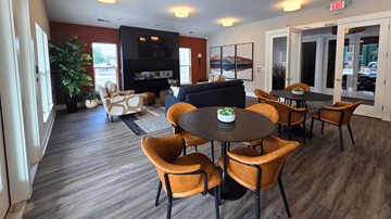 Delaware apartment for rent - A living room with a fireplace and a dining table with chairs.