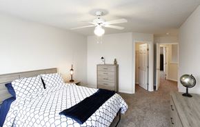 Beavercreek apartment for rent - a bedroom with a bed and a ceiling fan