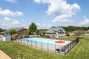 Springfield apartment for rent - a swimming pool with a fence and a house in the background