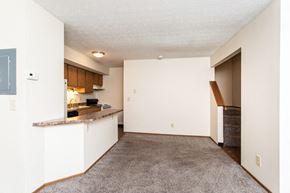 Delaware townhouse for rent - an empty living room and kitchen with a counter top