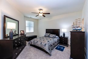 Canonsburg condo for rent - a bedroom with a bed and a ceiling fan