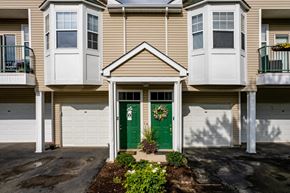 Canonsburg condo for rent - the front of an apartment building with green doors