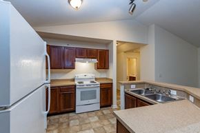 South Park Township condo for rent - a kitchen with white appliances and wooden cabinets