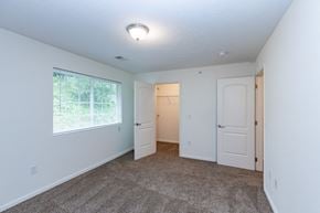 South Park Township condo for rent - a bedroom with a large window and a door to a closet