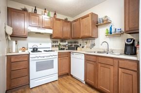 Galloway apartment for rent - a kitchen with white appliances and wooden cabinets