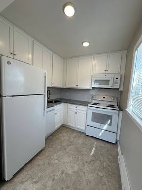 New Milford apartment for rent - a kitchen with white appliances and white cabinets