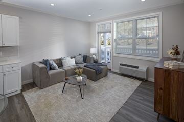 Denville apartment for rent - A living room with a grey couch and a coffee table.