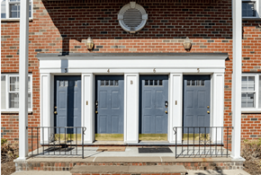 Paterson apartment for rent - A red brick house with a blue front door.