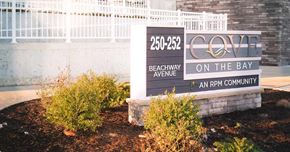 Keansburg apartment for rent - Exterior Sign with logo and address with plants in front of building
