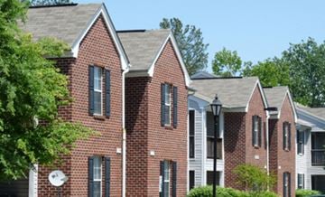 Richmond apartment for rent - A red brick building with a satellite dish on the left side.