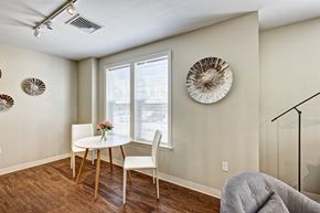 Suffield apartment for rent - Dining nook is brightly lit and features large windows and modern wood flooring.