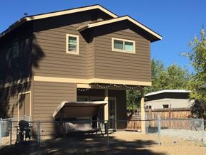 Flagstaff house for rent - a home with a fenced in yard and a fence